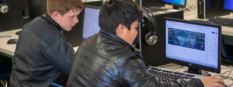 Two boys working in computer lab