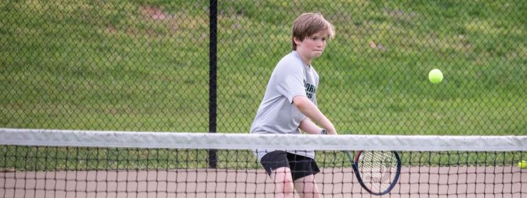 Boy playing tennis