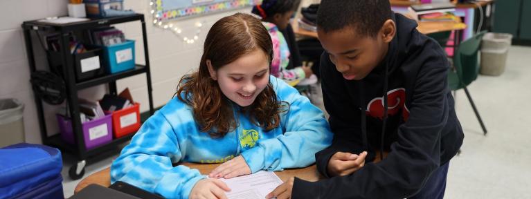 Girl and boy at desk working