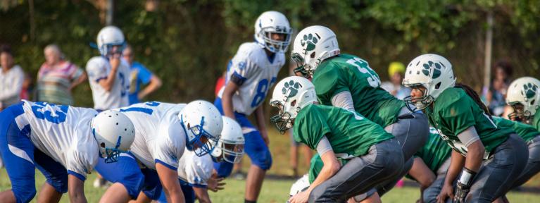 Football players at line of scrimmage