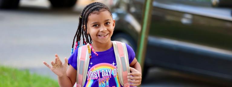 Student with backpack outside school