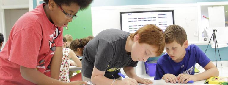 Three boys working on activity