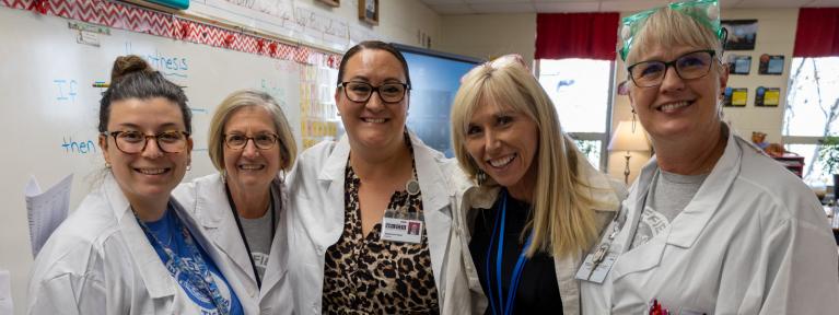 5 educators in lab coats for STEM day