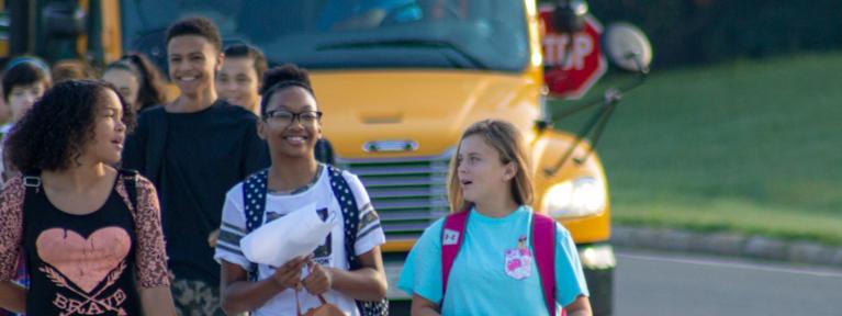 Students walking into school from bus