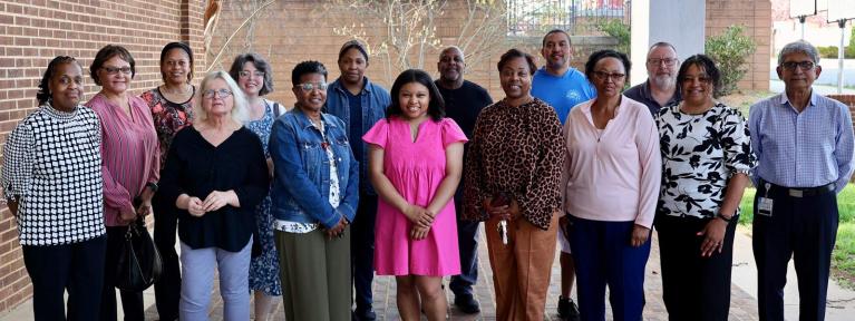 Group of staff members who were named their school's support person of the year, standing together outside the School Administration Building